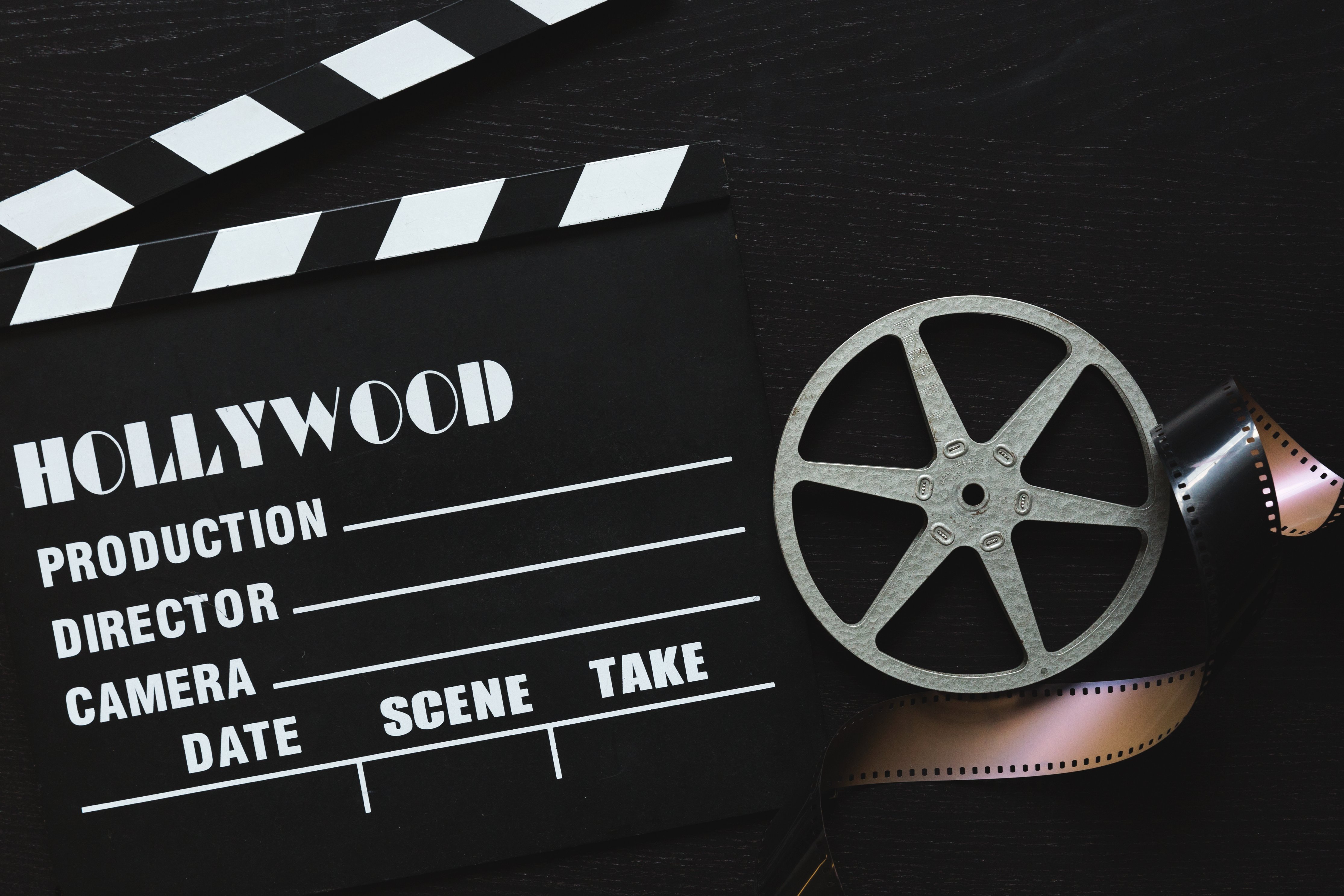 a-movie-clapper-board-film-roll-and-sprocket-wheel.jpg